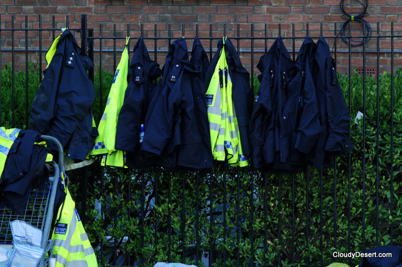 Police uniforms hanging on a rail